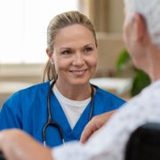 Smiling nurse in front of patient